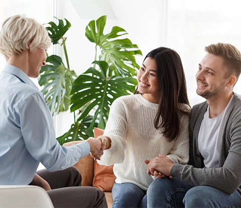 happy psychotherapist and couple handshake